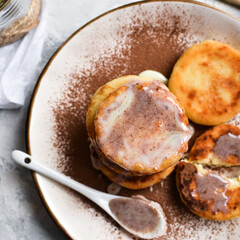 Sweet cottage cheese pancakes. Condensed milk. Festive sweet breakfast or lunch. Light background. Top view