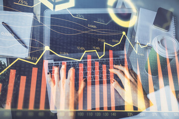 Double exposure of woman hands typing on computer and forex chart hologram drawing. Stock market invest concept.