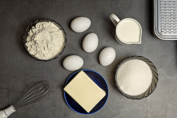 Ingredients for making waffles at home. Eggs, flour, milk, sugar, condensed milk, and a wire whisk. Step-by-step instructions. step 1.