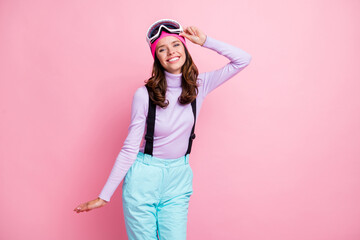 Naklejka premium Photo of sweet cute woman skier dressed violet sweater arm goggles mask having rest isolated pink color background