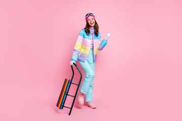 Full length photo of shiny lady snowboarder wear colorful coat eyewear walking holding sled arm...