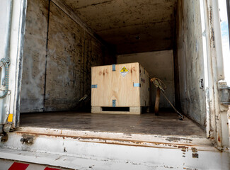 Radiation label beside the transport wooden box Type A package in the truck