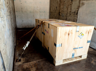 Radiation label beside the transport wooden box Type A package in the truck