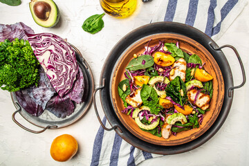 Ketogenic, paleo diet breakfast. Purple cabbage, avocado, spinach, tomatoes, fillets and nuts. Delicious breakfast or snack on a light background, top view.