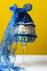 unusual hand knit baby hat on a yellow background 