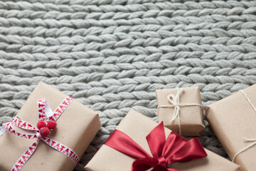 Gift boxes with ribbons on a handmade knitted cozy background. 
Valentine's Day presents. Happy Birthday. Love consept.