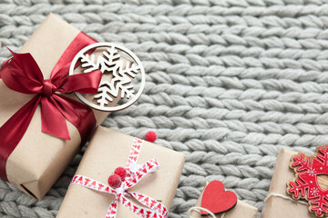 Gift boxes with ribbons on a handmade knitted cozy background. 
Valentine's Day presents. Happy Birthday. Love consept.