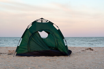 Tent by the sea at sunset. Tracking. Leisure. Outdoor.