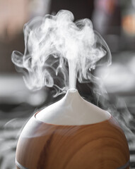 Modern oil aroma diffuser close up on a blurred background.