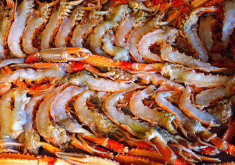 Fresh langoustines cut in half on a baking sheet