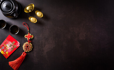 Chinese new year festival decorations pow or red packet,  and gold ingots or golden lump on dark...