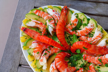 Platter of fresh gambas salad with pineapple and avocado