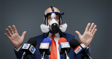 Politician wearing a respirator and giving a speech