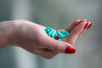 female doctor hands hold green pills