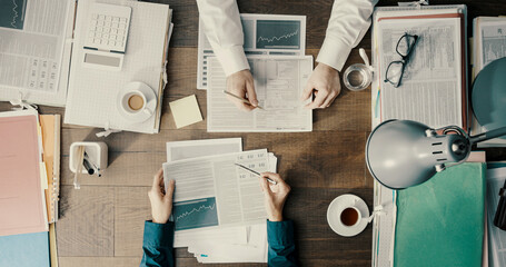 Business people working together and checking financial charts - obrazy, fototapety, plakaty
