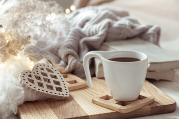 White cup with drink on blurred background home decor.
