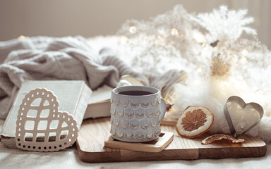 Home composition with beautiful cup on blurred cozy background.