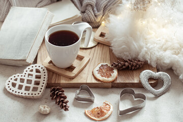 Home composition with a cup of drink and cozy decor details.