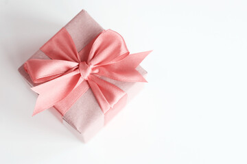 Brown paper gift box with beautiful satin ribbon, monochrome pink toned design, pastel colours. Universal gifts design for all kind of shopping and celebration