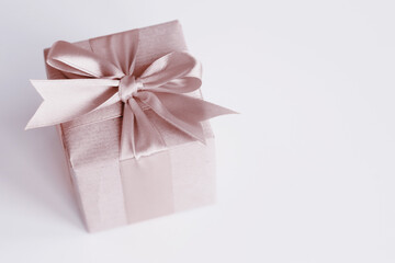 Brown paper gift box with beautiful satin ribbon, monochrome toned design, pastel colors. Universal gifts design for all kind of shopping and celebration