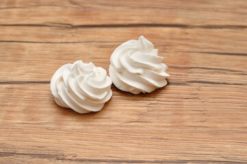 Two white meringues on a table