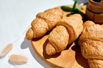 Traditional French croissant on white table background, tasty breakfast with croissants, Fresh bakery, top view, hard light.