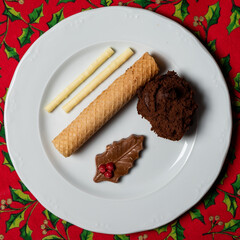 A flat lay image of a decorated chocolate mousse Dutch translation: Hiemelse Modder with grandmother`s receipe. A typical dessert in Maastricht during the Christmas holidays.