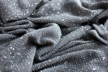 Silver-tone fabric with beading. Metallic gray background.