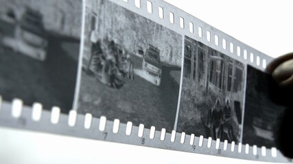 Watching Retro Pictures on Negative Plastic Film Strip