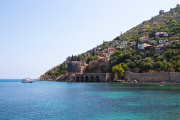 Fototapeta premium Landscape of ancient shipyard near of Kizil Kule tower in Alanya peninsula, Antalya district, Turkey, Asia. Famous tourist destination with high mountains. Part of ancient old Castle