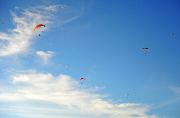 Colorful paraglidins flying in the sky