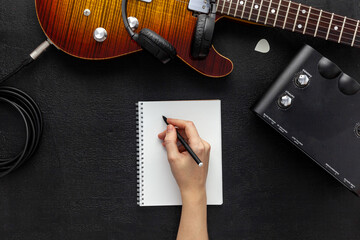 Desk of musician for songwriter work set with headphones and guitar