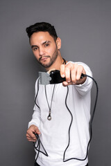 Men with hair clipper in hands on gray background