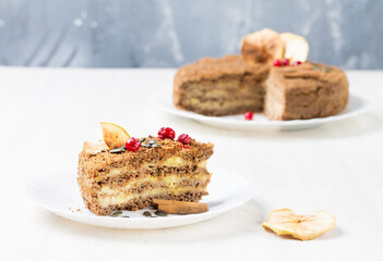 A piece of gluten-free, egg-and milk-free nut cake with creamy Apple filling on a white plate, in the foreground.