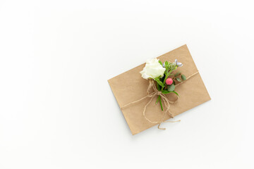 Composition with craft envelope and delicate flowers