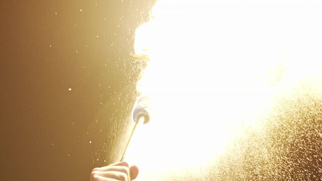 Fire spitting. Male fire artist performs outside