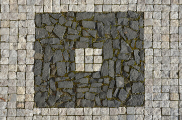 mosaic of small marble cubes. sidewalks and squares formed by stone carpet with squares, polka dots...