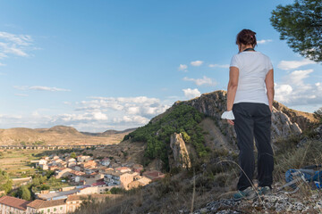 Fototapeta premium Woman looking at buildings of Alhama de Aragon in Zaragoza, Aragon, Spain, Europe