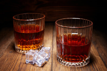 Whiskey in glasses on wooden table