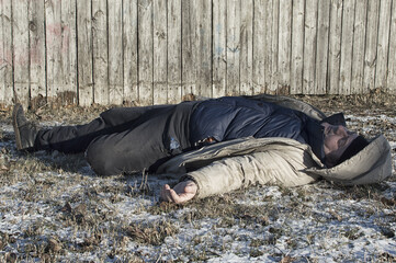 Murder. The body of a man lies on the melting snow. Brutal crime.