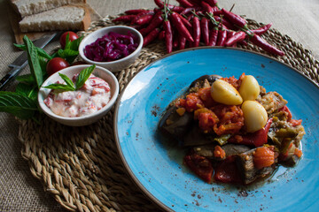 Eggplant meal with tomato sauce with lots of garlic and salad.