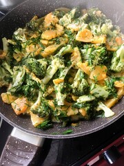 homemade food - stewed pumpkin with cauliflower in a large skillet