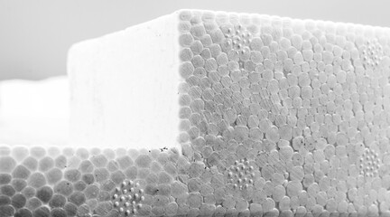 closeup of white smooth texture polystyrene foam plastic of cell pattern balls as a cube square corner - obrazy, fototapety, plakaty