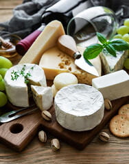 Various types of cheese, grapes and wine