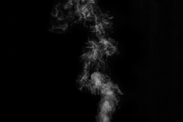 White smoke on black background. Figured smoke on a dark background. Abstract background, design element, for overlay on pictures