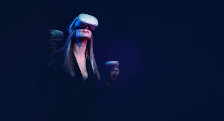young woman with blond hair in a vr helmet looks around with surprise and delight - 401971506