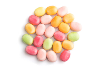 Heap of multicolored caramel candies isolated on white background. close up, top view.