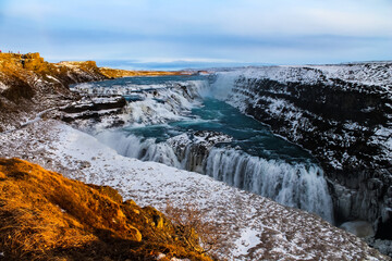 Early sunset over big waterfall in Iceland.