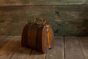 Vintage handbag on a wooden background.
