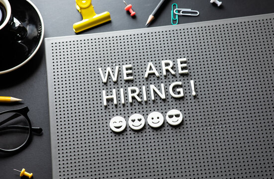 We are hiring text on desk.business team.job interview